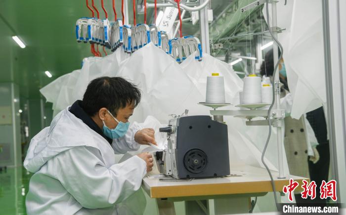 工人生產(chǎn)防護(hù)服，保障抗疫物資供應(yīng)。廣安市委宣傳部供圖