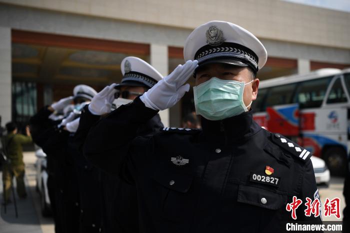 圖為交警們向醫(yī)療隊敬禮?！】灯?攝